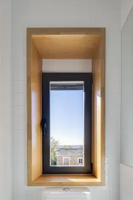 a window in a bathroom with a view of a building at Casa la Devesa de Sanabria in Remesal