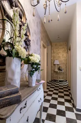 a hallway with flowers in vases on a dresser at La Casona de Nené in Arzúa