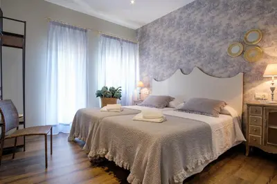 a bedroom with a large bed with two towels on it at La Casona de Nené in Arzúa
