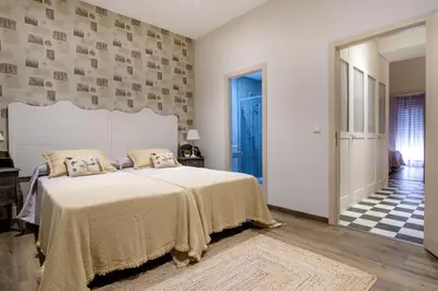 a bedroom with a large bed in a room at La Casona de Nené in Arzúa