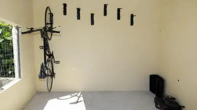 a room with a bike hanging on the wall at El Albergue del Montero in Mondoñedo