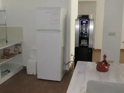 a kitchen with a refrigerator and a coffee maker at El Albergue del Montero in Mondoñedo