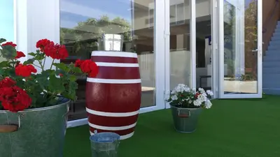 a red and white striped pole next to two potted plants at El Albergue del Montero in Mondoñedo