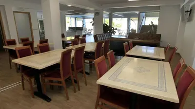 a dining room with wooden tables and chairs at El Albergue del Montero in Mondoñedo