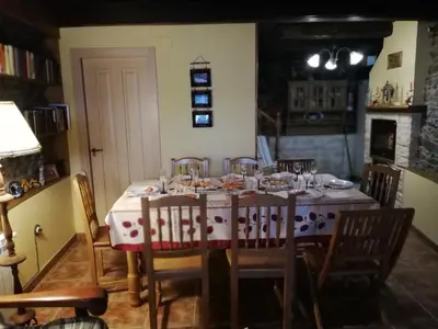 a dining room with a table with chairs and a table cloth at Casa Bell in Manzanedo de Valdueza