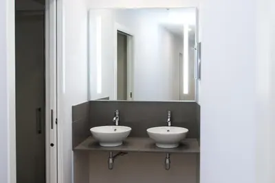 a bathroom with two sinks and a mirror at Albergue Linares in Santiago de Compostela
