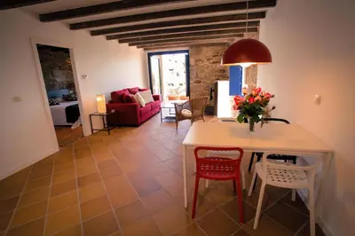 a living room with a table and chairs at Apartamentos Ribeira Sacra in Parada del Sil