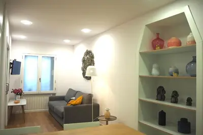 a living room with a couch and a window at A Fonte das Hortas Residencial in Santiago de Compostela