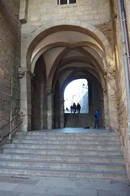 an archway with stairs and people walking through a building at A Fonte das Hortas Residencial in Santiago de Compostela