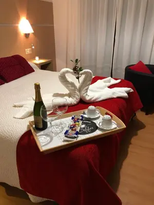a tray with a bottle of wine and glasses on a bed at Casa Blanco Conde in Laza