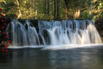 a waterfall in the middle of a body of water at Casa Blanco Conde in Laza