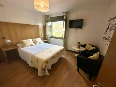 a bedroom with a large bed and a window at Casa Blanco Conde in Laza