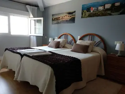 a bedroom with two beds and a window at Hostal Buenavista in San Ciprián