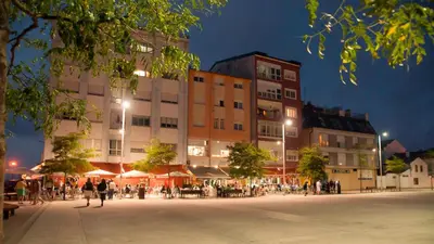 a building with tables and people in front of it at Hostal Buenavista in San Ciprián