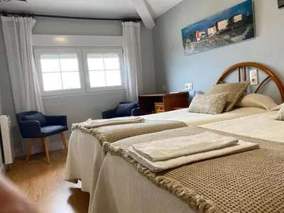 a bedroom with two beds and a window at Hostal Buenavista in San Ciprián
