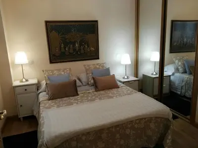 a bedroom with a large bed with two lamps at Foz Playa y Mar by I Love Norte in Foz