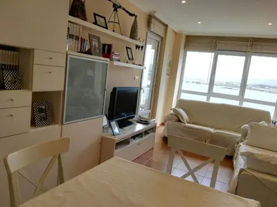 a living room with a flat screen tv and a couch at Foz Playa y Mar by I Love Norte in Foz