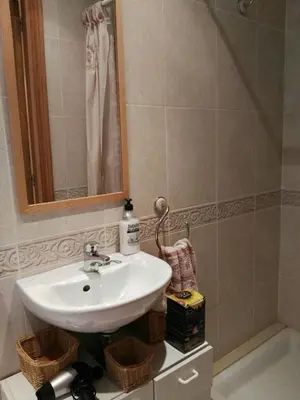 a bathroom with a sink and a mirror at Foz Playa y Mar by I Love Norte in Foz