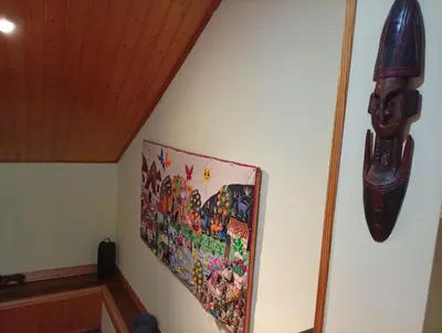 a painting hanging on a wall next to a ceiling at Casa de Abril 1 in San Cristóbal de Valdueza