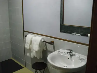 a bathroom with a sink and a toilet and a mirror at La Candela in Rabanal del Camino
