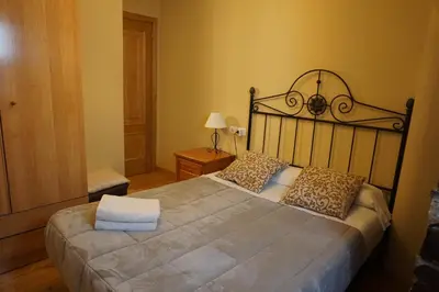 a bedroom with a large bed in a room at Casa Morrosco in Molinaseca