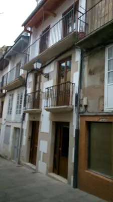 a building with balconies on the side of a street at Apartamento con balcón in Viveiro