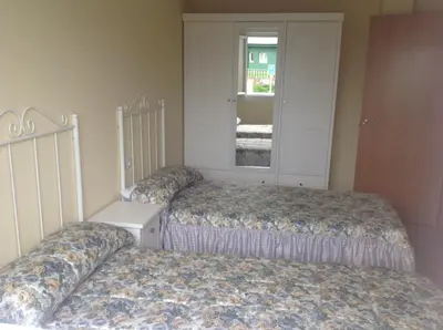 a bedroom with two beds and a window at Apartamentos Alejandra in Barreiros