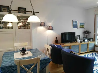 a dining room with a table and chairs and a television at San Ciprián Playa y Mar by I Love Norte in San Ciprián