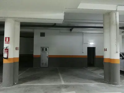 an empty parking garage with columns and a door at San Ciprián Playa y Mar by I Love Norte in San Ciprián