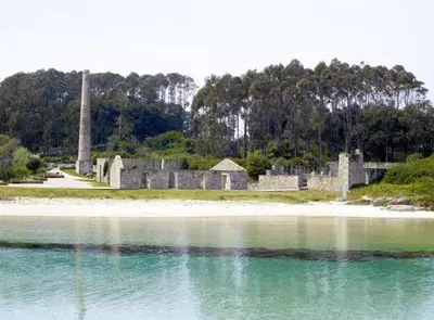 an old castle on the shore of a body of water at San Ciprián Playa y Mar by I Love Norte in San Ciprián