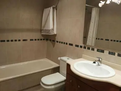 a bathroom with a sink and a toilet and a tub at San Ciprián Playa y Mar by I Love Norte in San Ciprián