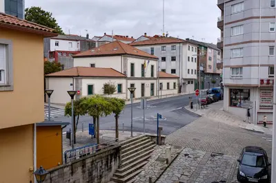 a view of a city street with buildings at Albergue Pensión Cima do Lugar in Arzúa