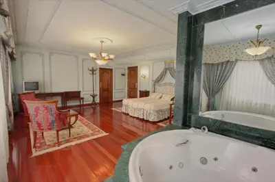 a bathroom with a tub and a bedroom with a bed at Pazo de Monterrei in Ourense