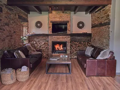 a living room with two couches and a fireplace at Aldea Rural y Gastro Restaurante Casona de Labrada in Labrada
