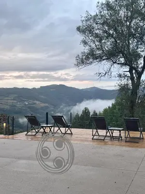 a group of chairs sitting on a deck with a view at Aldea Rural y Gastro Restaurante Casona de Labrada in Labrada