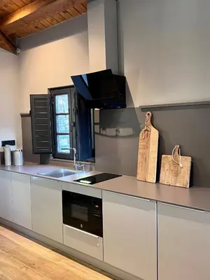 a kitchen with a sink and a stove top oven at Aldea Rural y Gastro Restaurante Casona de Labrada in Labrada