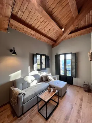 a living room with a couch and a table at Aldea Rural y Gastro Restaurante Casona de Labrada in Labrada