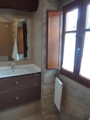 a bathroom with a sink and a mirror at Casa do Forno in Castro de Oro