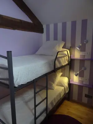 a bedroom with a bunk bed and two lamps at Casa do Forno in Castro de Oro