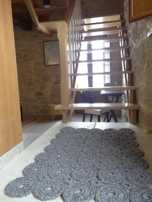 a rug on the floor in a room with stairs at Casa do Forno in Castro de Oro