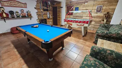 a living room with a pool table and a pirate ship at Casa da Curuxeira in Santiago de Compostela