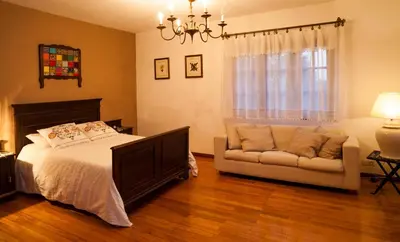 a bedroom with a bed and a couch at Casa da Curuxeira in Santiago de Compostela