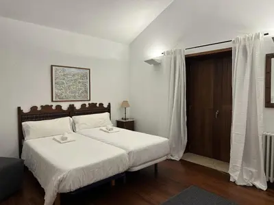 a bedroom with a large bed with white sheets at Casa Boado in Boimorto