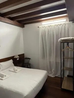 a bedroom with a white bed and a window at Casa Boado in Boimorto