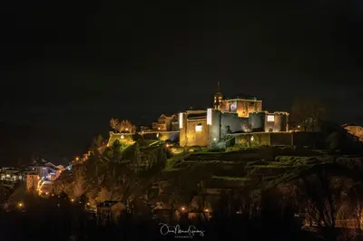 a castle on top of a hill at night at Casa Rural 