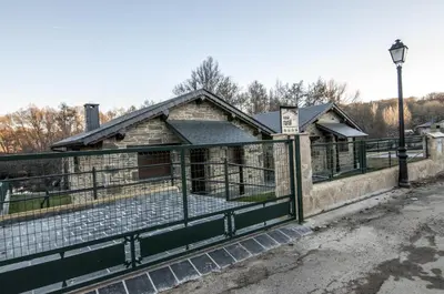 an old building with a fence in front of it at Casa Rural 