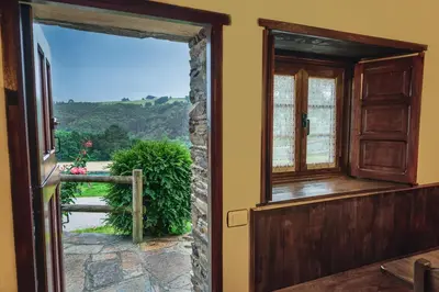 an open door to a balcony with a view at Apartamentos Rurales Casa Riveras in Santa Eulalia de Oscos