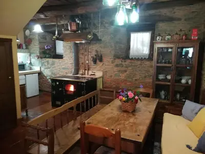 a bathroom with a sink and a toilet and a mirror at Las 3 Negrillas in Toral de Merayo