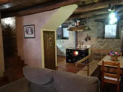 a hallway with a black door and a table and a staircase at Las 3 Negrillas in Toral de Merayo