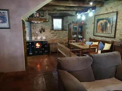 a porch with a pink bench and a table at Las 3 Negrillas in Toral de Merayo